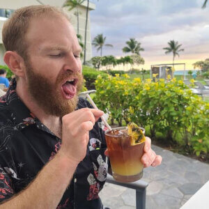 henry zebrowski drinking a cocktail with a straw